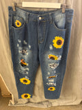 Blue ripped jeans with sunflower designs