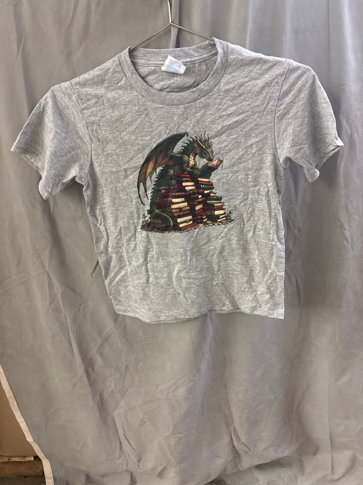 Kids dragon on a pile of books tshirt